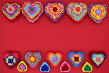 Obraz na płótnie Canvas Valentine's day. Background of hearts on a red background. Amigurumi, handmade, knitted.