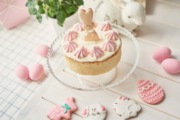 Easter composition with sweet bread, Easter cake, eggs, bouquet of flowers. Holidays breakfast concept with copy space. Traditional easter cake with gingerbread cookies. Easter Greeting Card Template