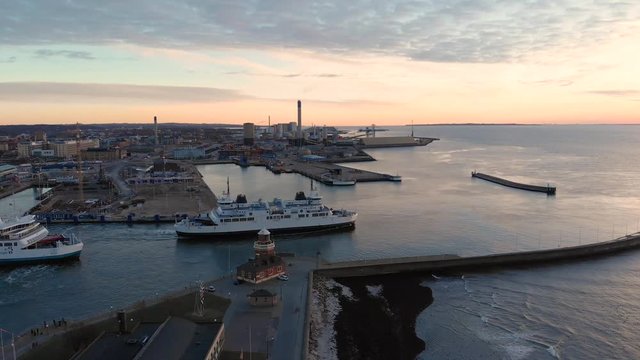 Aerial of ferry in Helsingborg, Sweden leaving the port and going to Denmark. Following sideways out into the sea