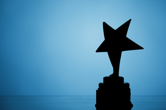 star trophy silhouette, blue background