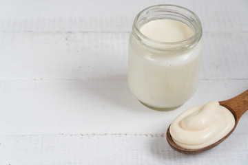 homemade yogurt in a spoon. wooden spoon with yogurt.