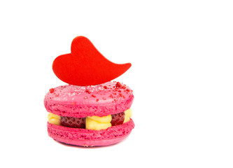 Cute pink macaroon cake with red heart shape tag for text. Fill in the Birthday or Valentine`s day card concept.