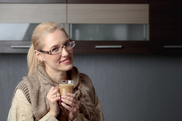 Portrait of a beautiful woman in glasses with cup of coffee.