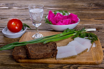 Russian tradition. A glass of vodka and a snack. Lard, black bread, pickled cabbage, pickled tomato, greens 3