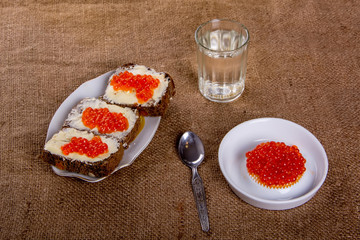 Russian tradition. A glass of vodka and a snack.Sandwiches of black bread with caviar. Caviar.  4