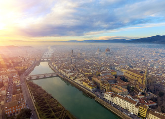 Naklejka premium AERIAL. Panorama of the city of FLORENCE in Italy with the dome and Palazzo della Signoria and arno river