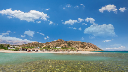 Agia Galini Beach in Crete island, Greece. Tourists relax and bath in crystal clear water of Agia...