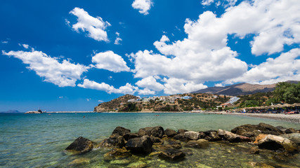 Fototapeta na wymiar Agia Galini Beach in Crete island, Greece. Tourists relax and bath in crystal clear water of Agia Galini Beach.