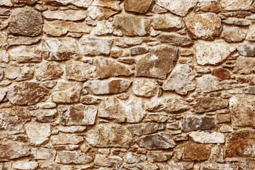 Mosaic stones construction backdrop. Grunge uneven brick wall pattern. Pieces of cracked blocks in concrete wall background.