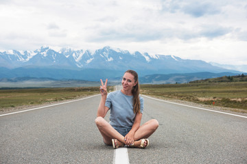 Woman sitting on the beauty road in mountain