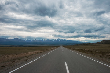 Fototapeta premium Empty route in Altai mountains on snowly peaks of North-Chui ridge of Altai mountains