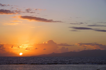 Naklejka na ściany i meble Sunrise view of the island and lagoon of Raiatea (Ra'iatea) near Tahiti seen from Bora Bora in French Polynesia, South Pacific