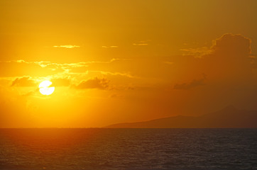 Sunrise view of the island and lagoon of Raiatea (Ra'iatea) near Tahiti seen from Bora Bora in French Polynesia, South Pacific