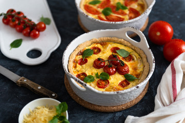 Vegetarian homemade pie, Quiche with tomatoes, basil leaves and cheese. Top view