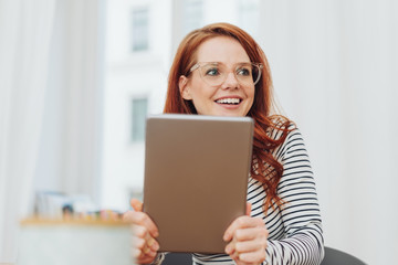 Fototapeta premium Young woman looking aside in amusement
