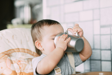 girl ON a CHAIR DRINKING TEA WITH GREY CIRCLES