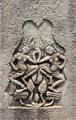 Fototapeta na wymiar Dancing Apsara of detail religious stone carving decorating on ancient wall Angkor Wat Temple at Siem Reap, Cambodia. Khmer architecture in the modern world. UNESCO World Heritage site