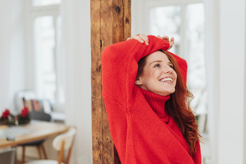 Relaxed cheerful young woman daydreaming