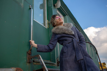 young woman in train station at sunny winter day