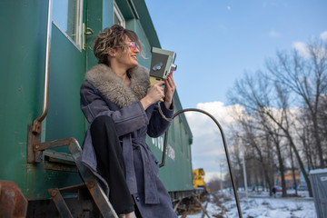young woman in train station at sunny winter day