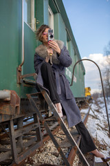 young woman in train station at sunny winter day