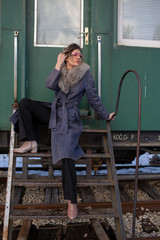 young woman in train station at sunny winter day