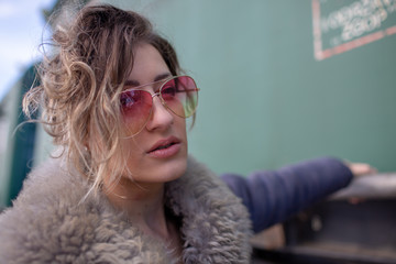 young woman in train station at sunny winter day