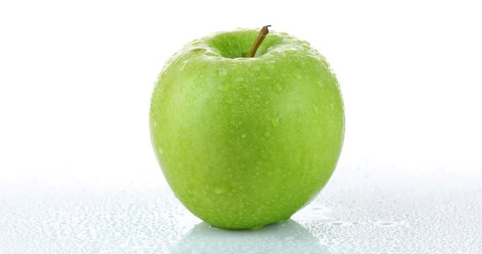 rotating green apple isolated on white background