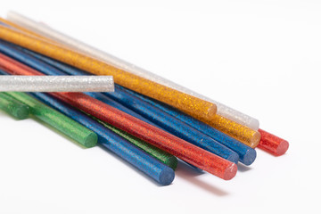 Coloured glue gun stick on white background