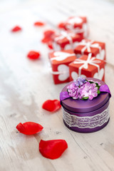 Valentine's Day background photo - rose petals with gift box