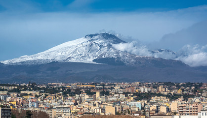 Majestic Etna in Sicily. In foreground buildings of Catania