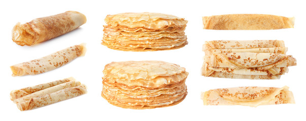 Set of rolled and stacked tasty thin pancakes on white background