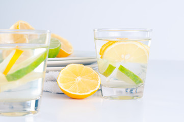 Glass of water with lemon and lime in it