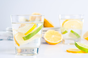 Glass of water with lemon and lime in it