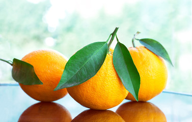 fresh ripe oranges with leaves