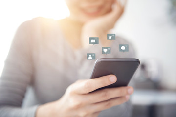 Woman hands using mobile smartphone with icon social media and social network. 