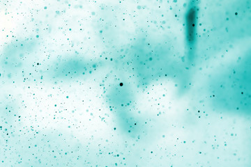 Abstract real green dust floating over white background.Dust paricles for overlay use in vintage or grunge design. Blurred dust concept.