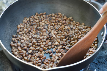 Roasted coffee beans in a pan, Traditional techniques.