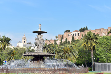 Fototapeta na wymiar Fountain with Alcazaba castle to the rear, Malaga, Costa del Sol, Malaga Province, Spain
