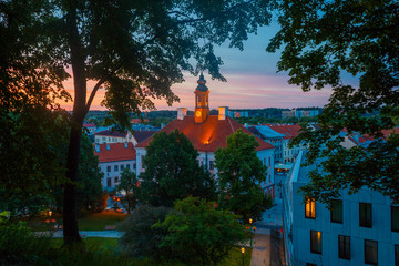 Summer sunset and the beautiful sky above the Tartu Town Hall and historical part of the city, view from the Dome hill. Tartu, Estonia