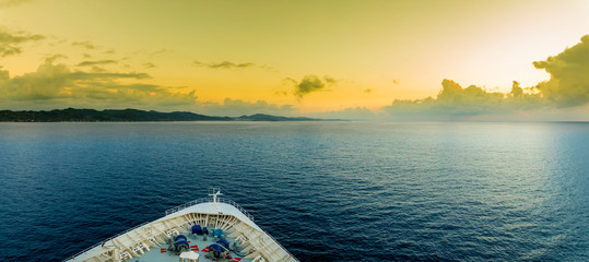 Panoramic view of the bow of a ship as it approaches the tropical island of Roatan.
