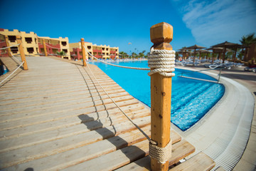 Bridge over swimming pool at tropical hotel resort