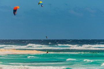 Kiteboarding off the beaches of Aruba in the high surf and on a windy day