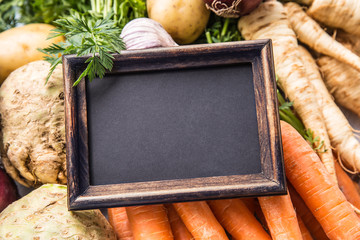 Top of view empty chalkboard on fresh vegetables