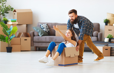 happy young married couple moves to new apartment.