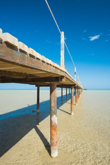 Wooden pier from beach on tropical sea