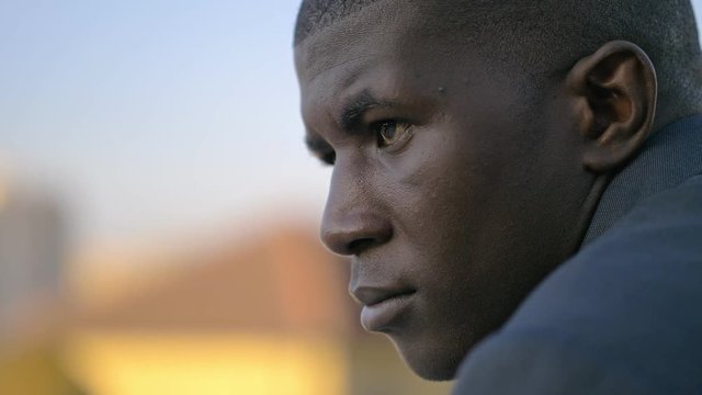 Portrait of a confident African American businessman contemplating the city