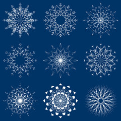 Naklejka premium Vector collection of artistic icy abstract crystal snow flakes isolated on background as winter december decoration group or collection. Ice or frost beautiful star ornament silhouette or season art