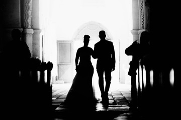 Entering a catholic church for a wedding in France while romanticism and beauty