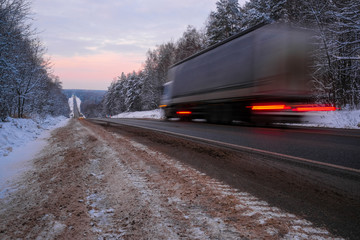  image of a truck on a winter road - obrazy, fototapety, plakaty